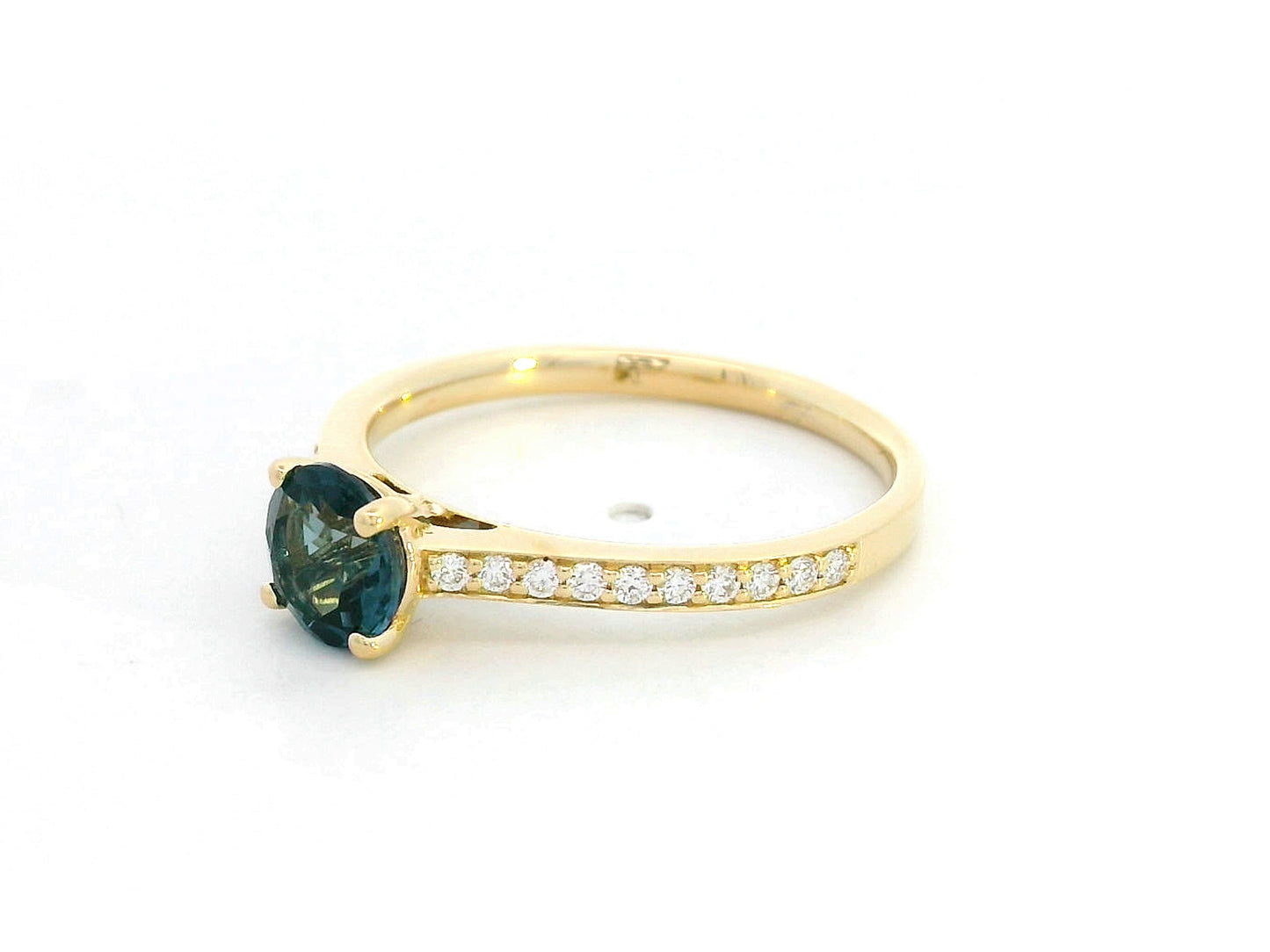 18K yellow gold ring with 0.93 carat round Blue Topaz center and 0.20 carat round diamond accents in fine prong setting along the band