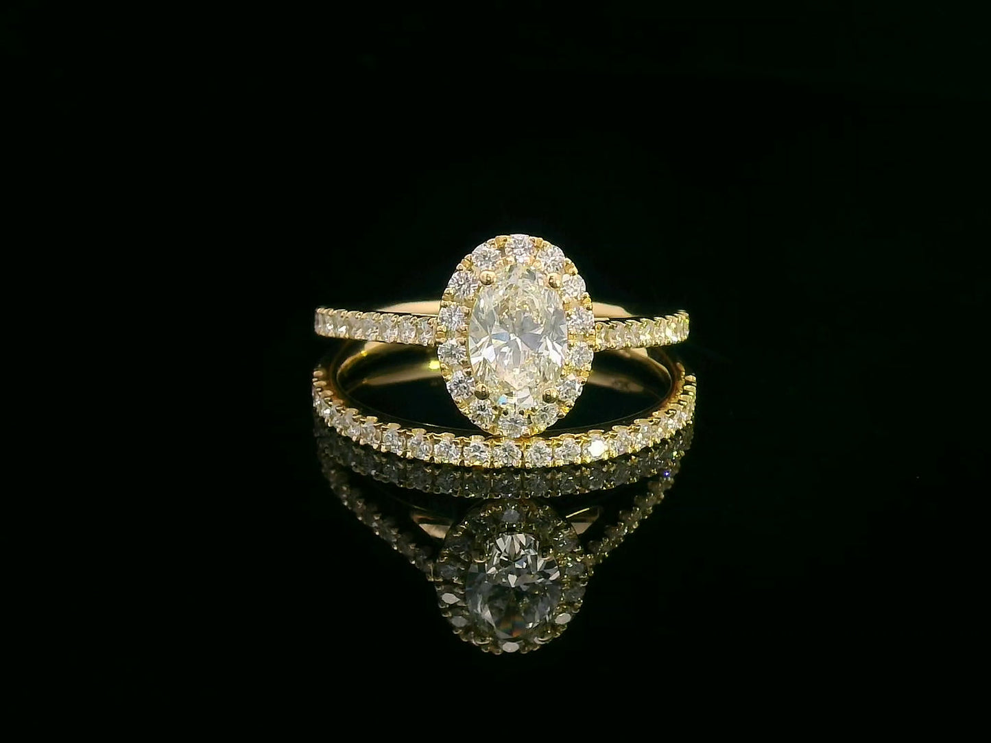 Oval diamond halo bridal set in 18K gold with pavé engagement ring and matching wedding band