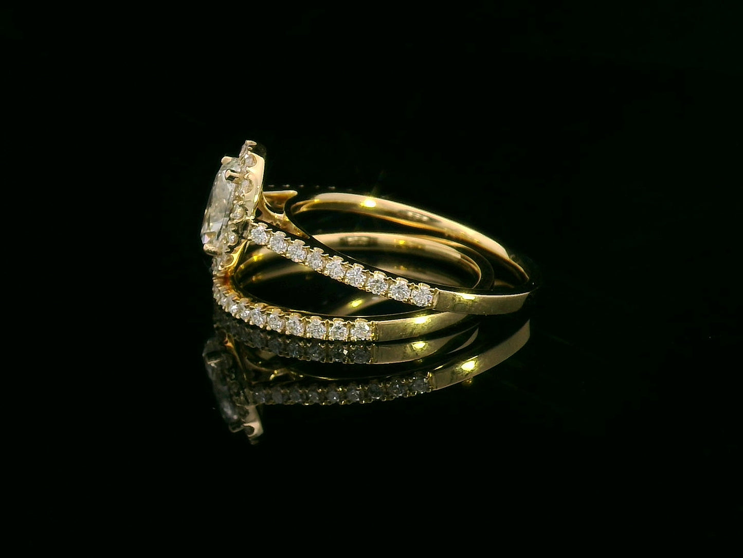 Oval diamond halo bridal set in 18K gold with pavé engagement ring and matching wedding band