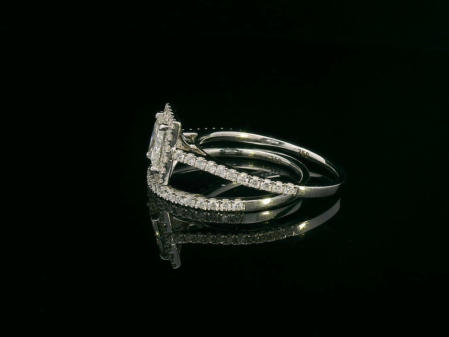 Princess cut diamond halo bridal set in 18K white gold with pavé-set engagement ring and matching band