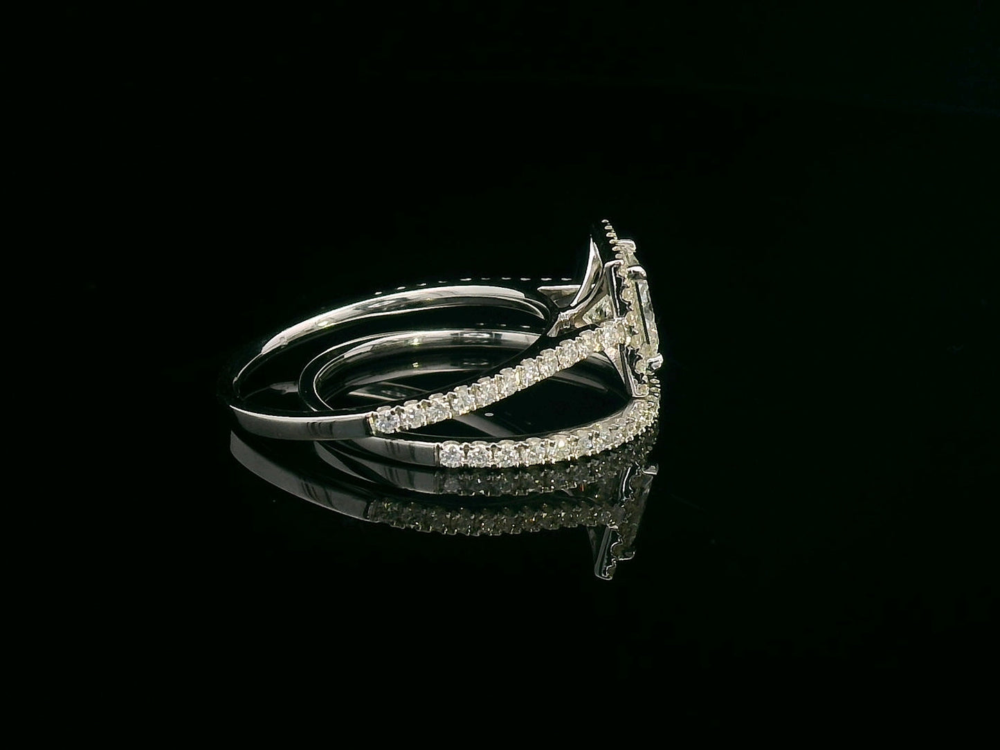 Princess cut diamond halo bridal set in 18K white gold with pavé-set engagement ring and matching band