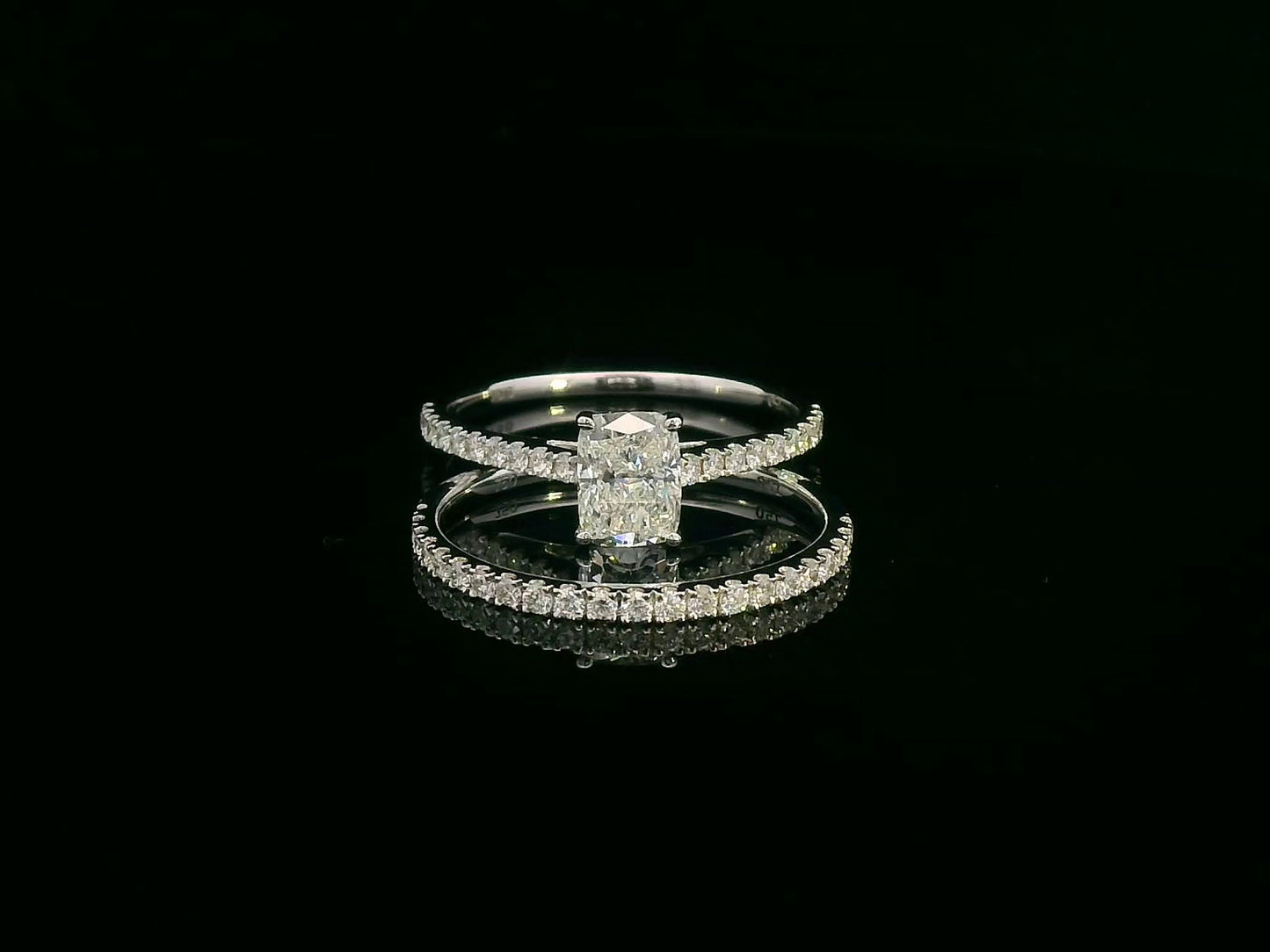 Cushion cut diamond bridal set in 18K white gold featuring pavé engagement ring and matching wedding band