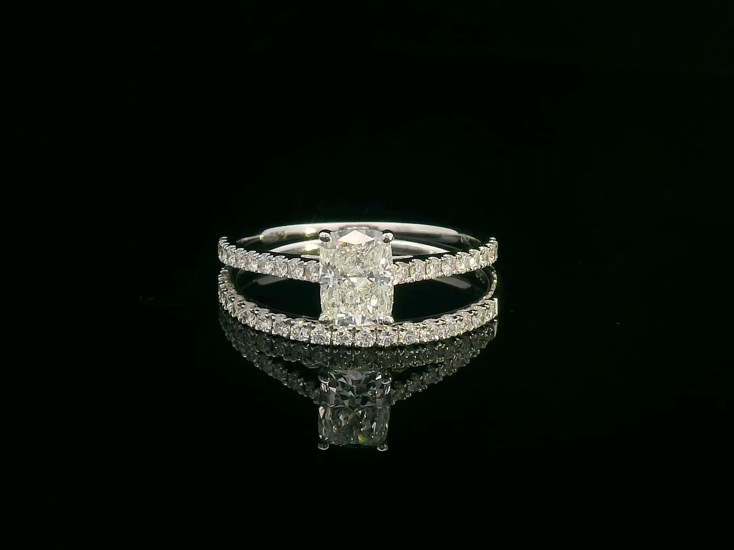 Cushion cut diamond bridal set in 18K white gold featuring pavé engagement ring and matching wedding band
