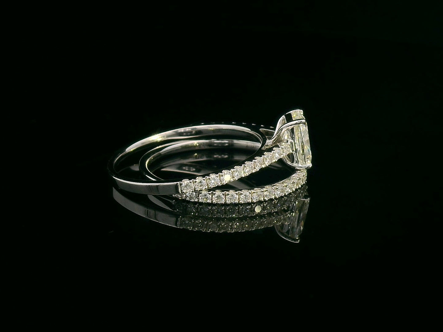 Cushion cut diamond bridal set in 18K white gold featuring pavé engagement ring and matching wedding band