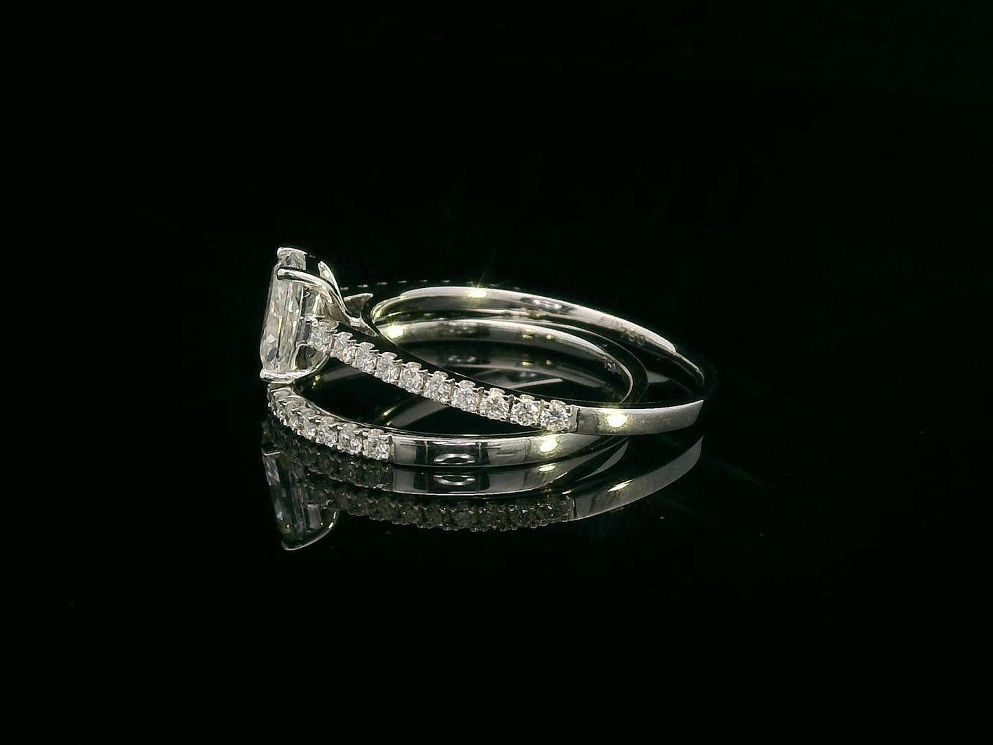 Cushion cut diamond bridal set in 18K white gold featuring pavé engagement ring and matching wedding band