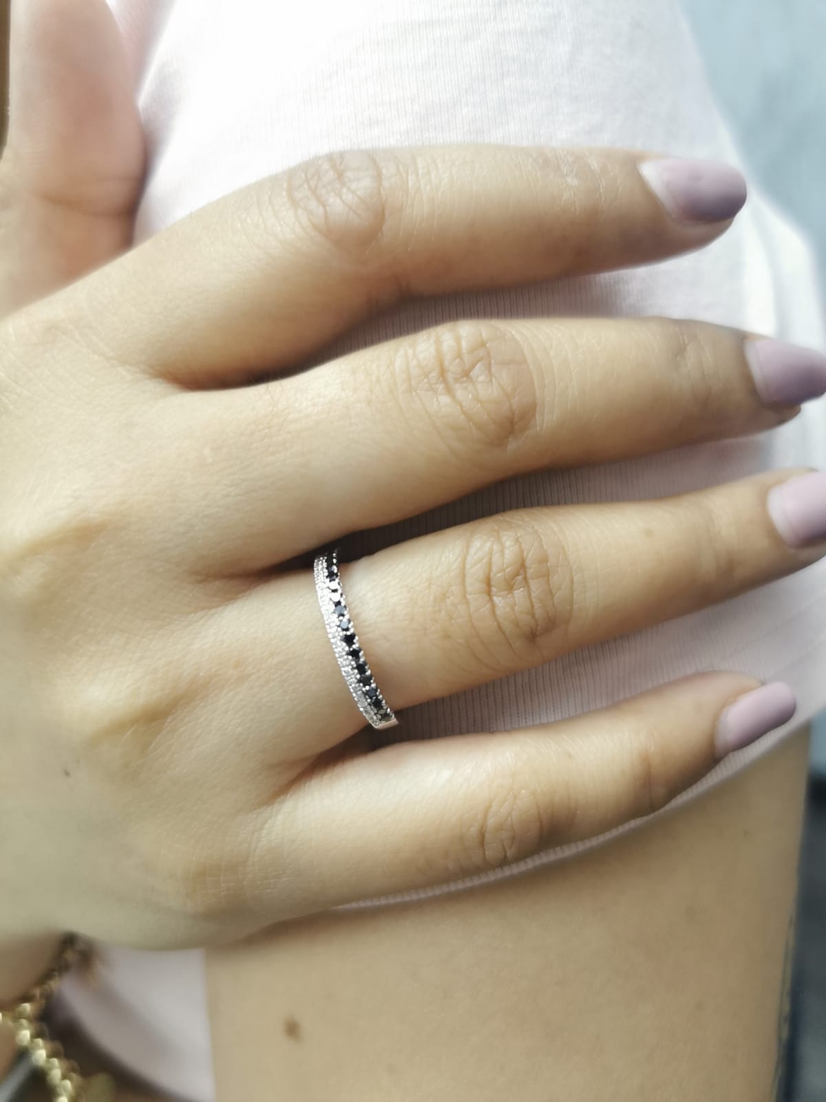 18K white gold ring with parallel rows of white and black diamonds in a modern half eternity band design.