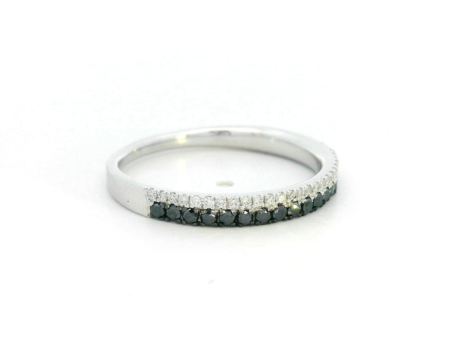 18K white gold ring with parallel rows of white and black diamonds in a modern half eternity band design.