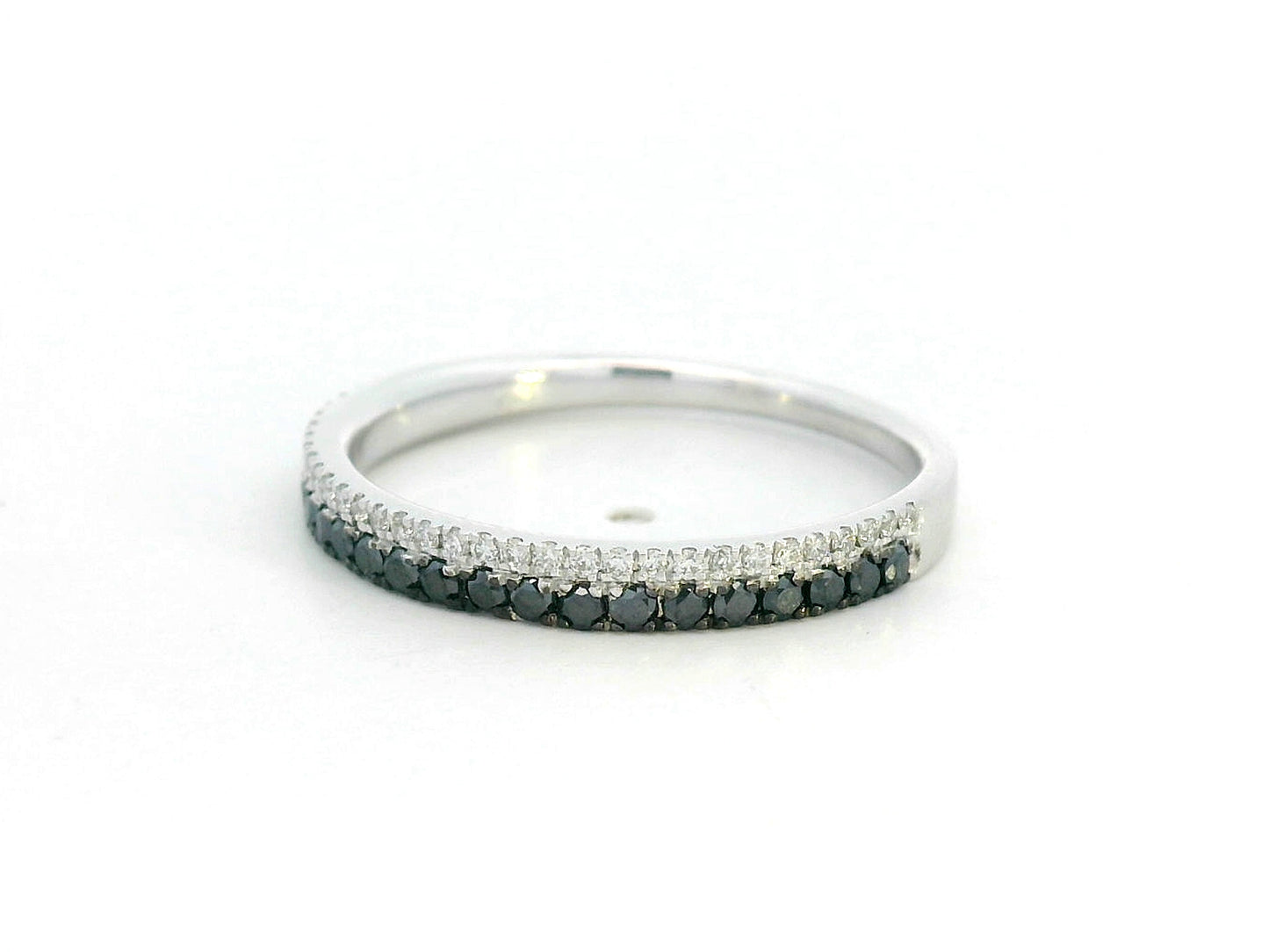 18K white gold ring with parallel rows of white and black diamonds in a modern half eternity band design.