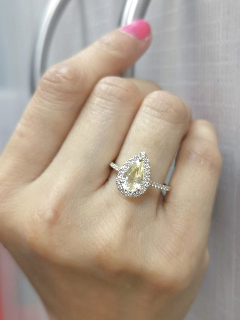 18K yellow gold ring with 2.18ct pear-shaped yellow sapphire and 0.48ct diamond halo and band
