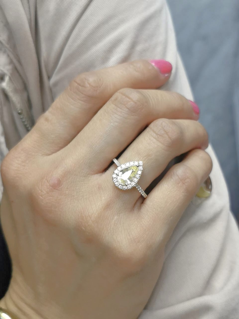 18K yellow gold ring with 2.18ct pear-shaped yellow sapphire and 0.48ct diamond halo and band