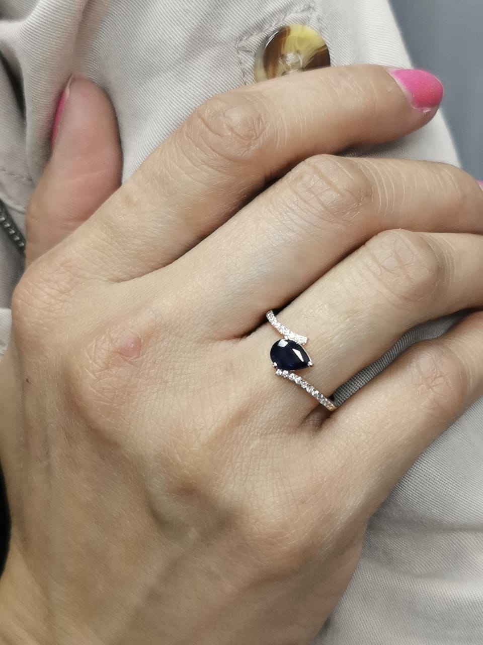 18K rose gold ring with pear-shaped blue sapphire and pavé diamond band