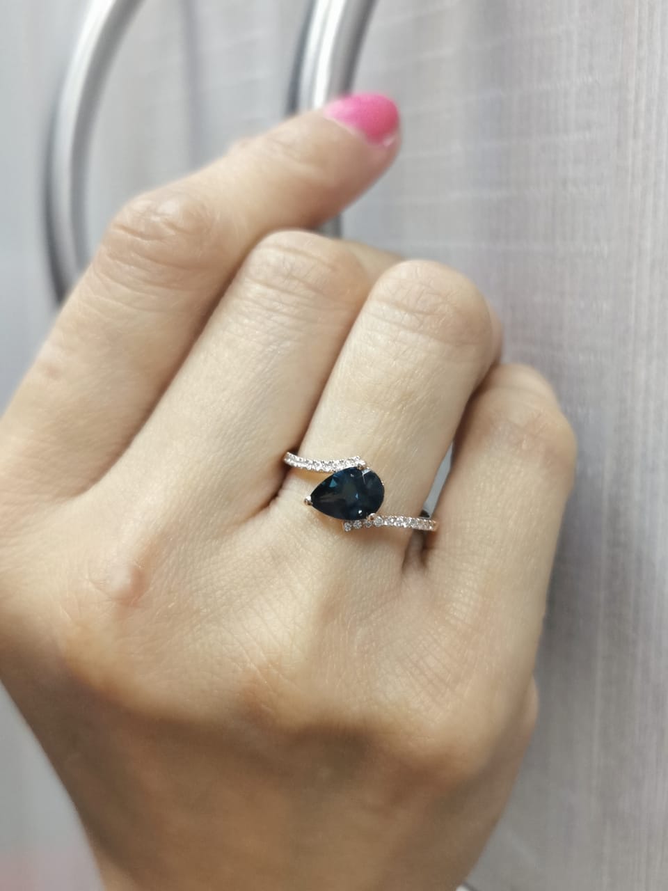 18K rose gold ring with pear-shaped London Blue Topaz and pavé diamond band