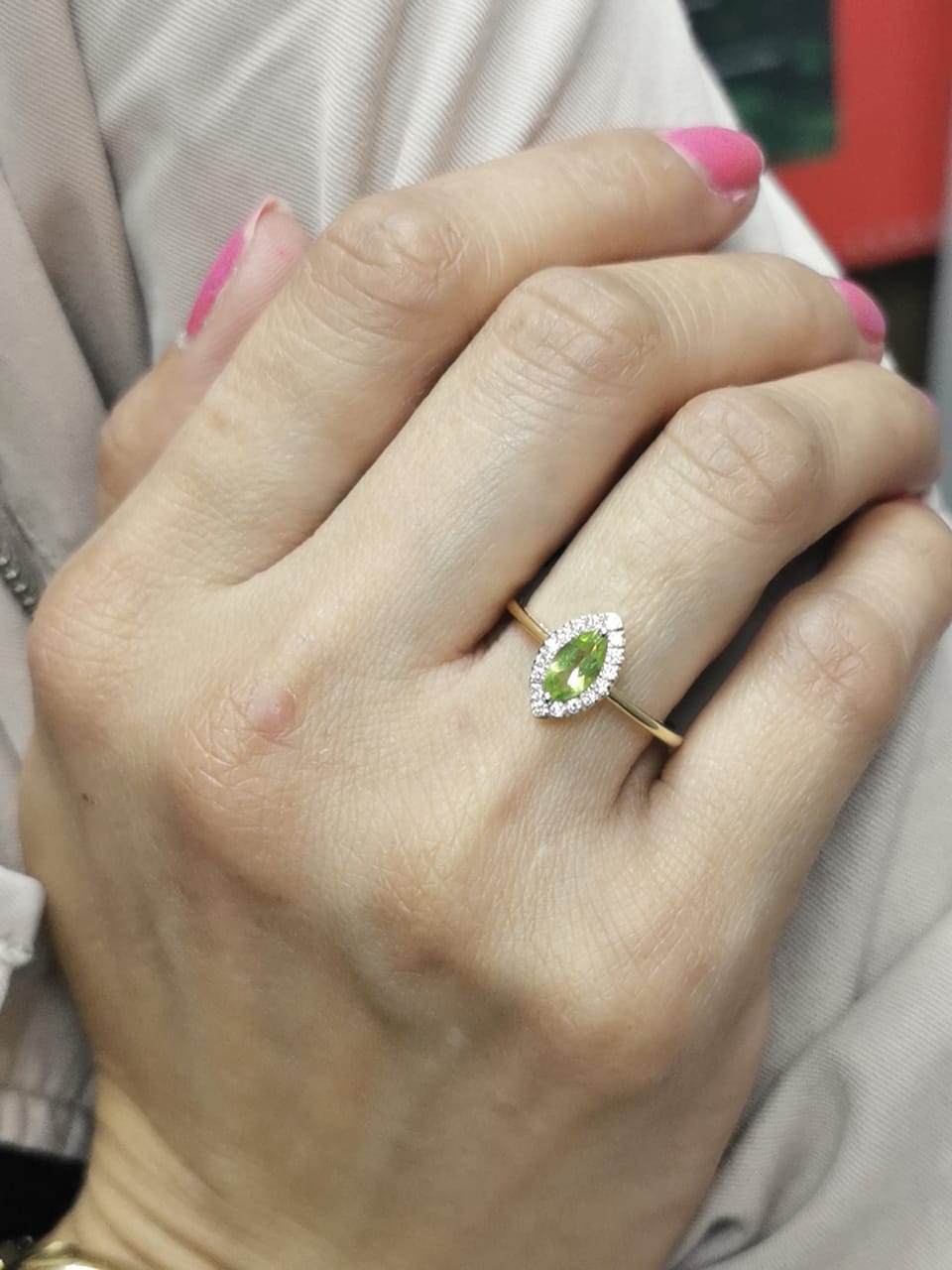 18k yellow gold ring featuring a 0.64ct marquise Peridot surrounded by a 0.15ct diamond halo