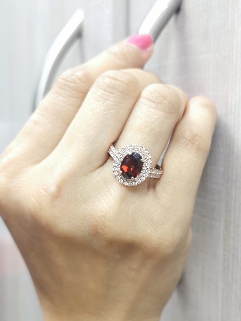 18K rose gold ring with oval garnet and double diamond halo – 2.24ct garnet, 0.63ct diamonds