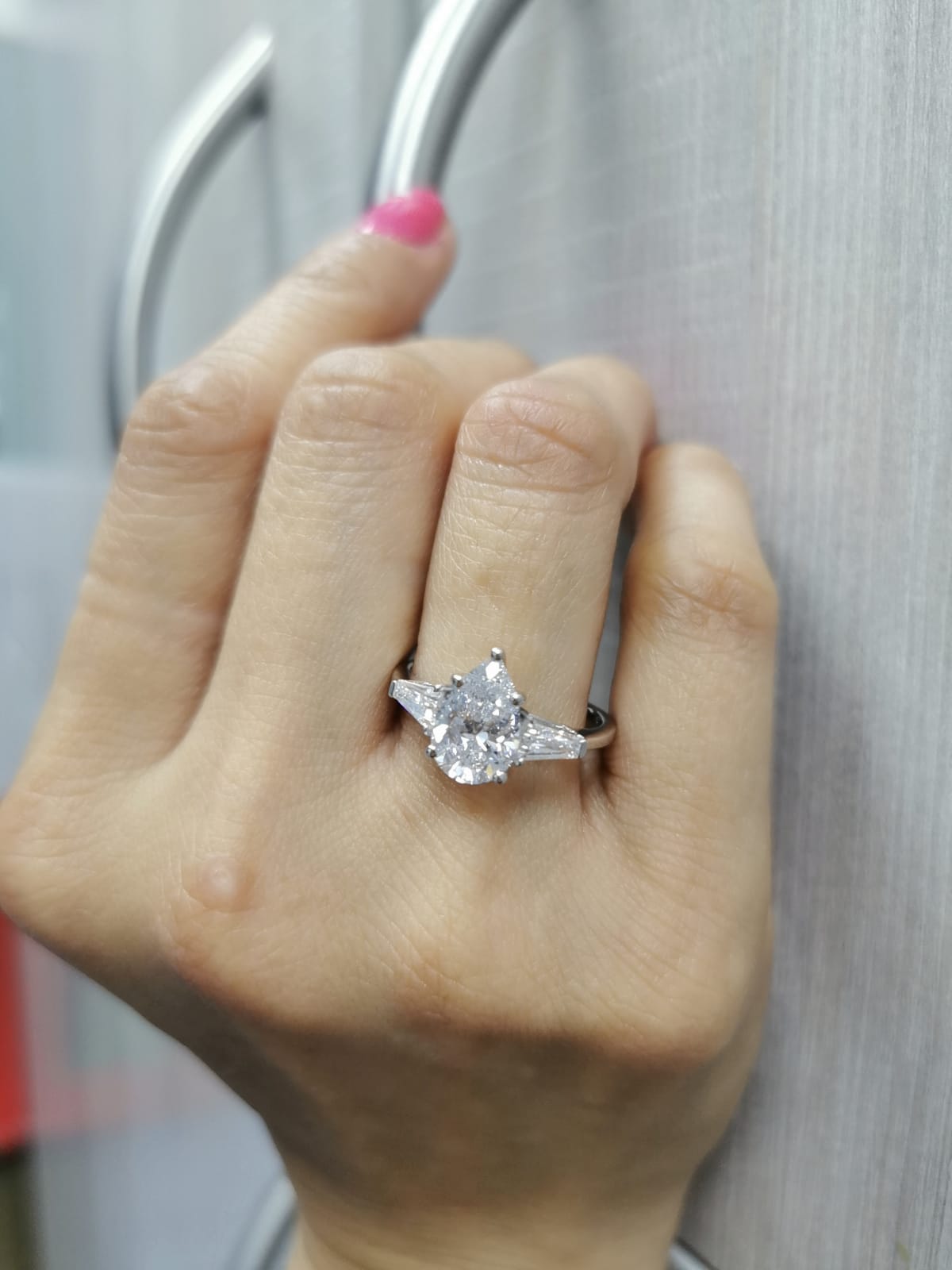 18K white gold ring with 2.01 carat pear-cut GIA-certified diamond and tapered baguette side stones
