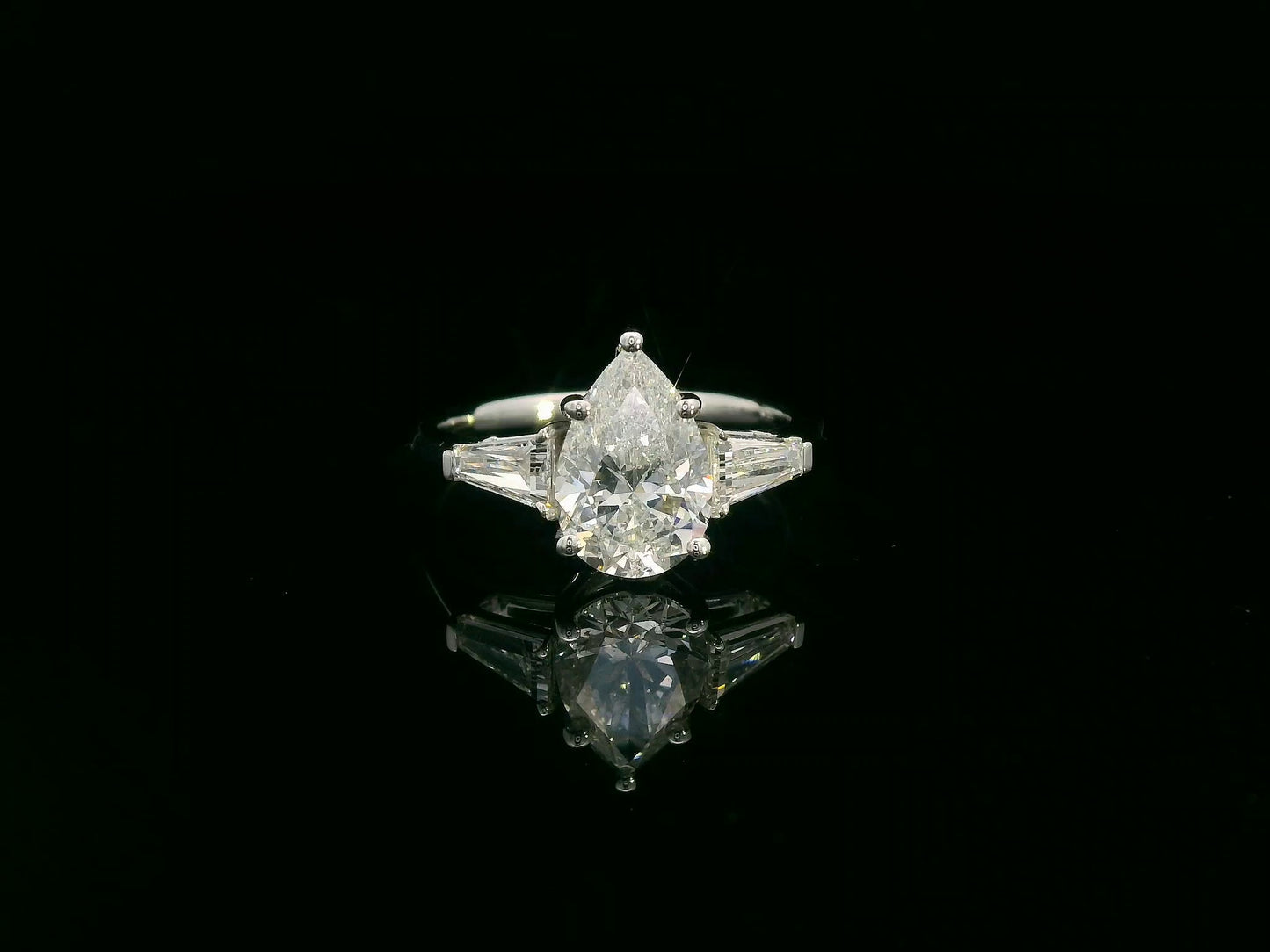 18K white gold ring with 2.01 carat pear-cut GIA-certified diamond and tapered baguette side stones