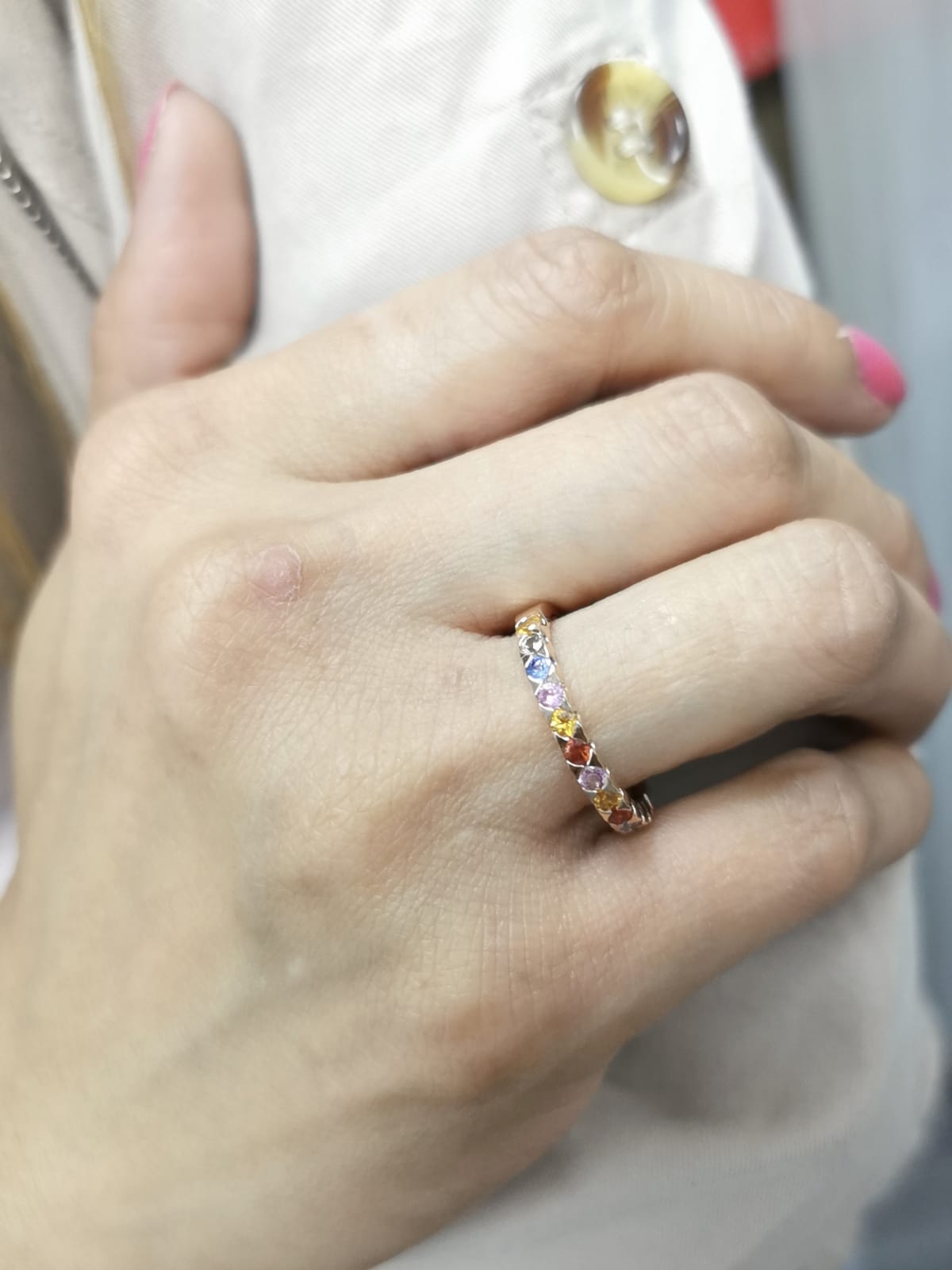 18K rose gold ring set with 0.93 carats of multicolored round sapphires in a half band design