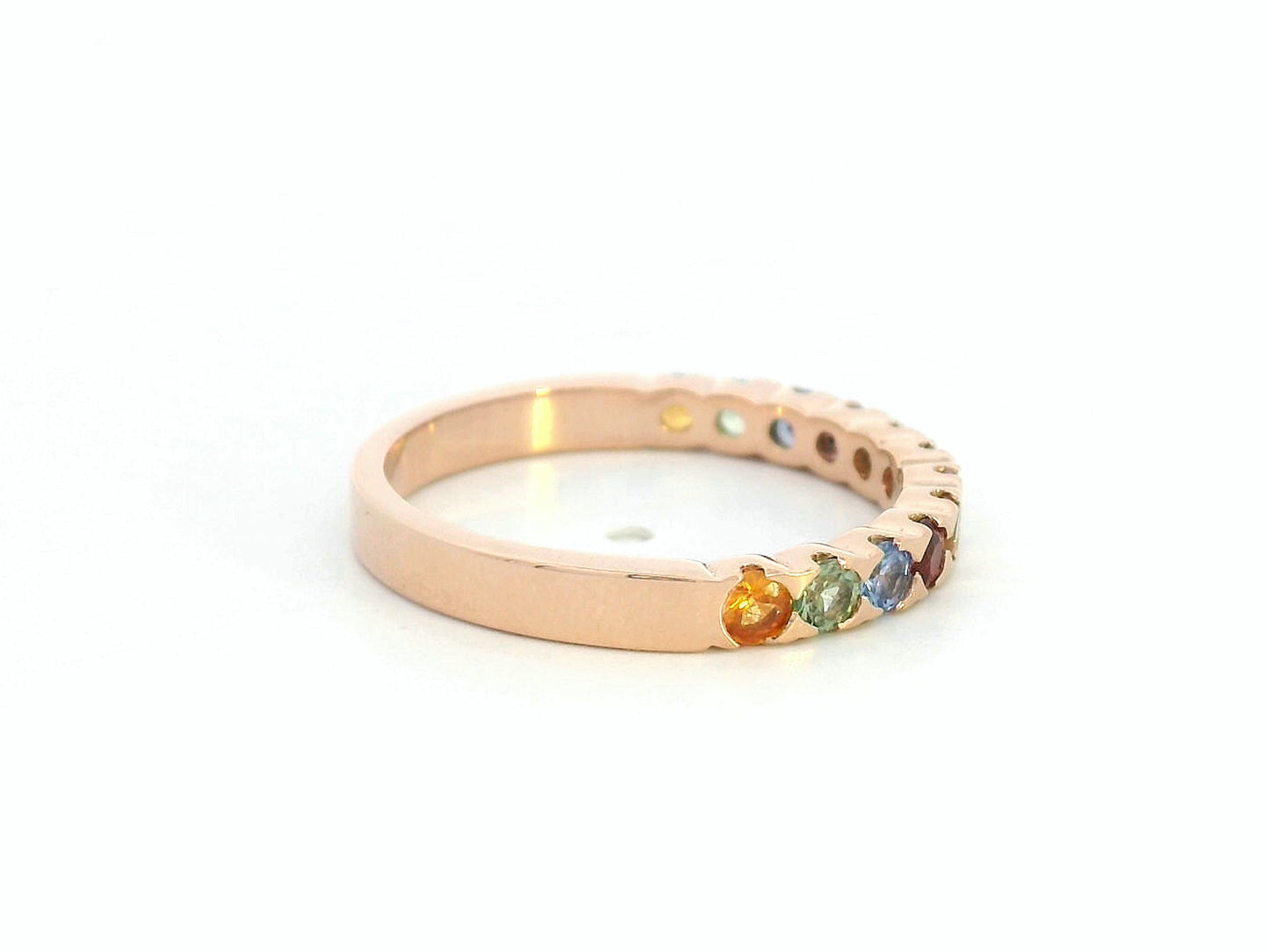 18K rose gold ring set with 0.93 carats of multicolored round sapphires in a half band design