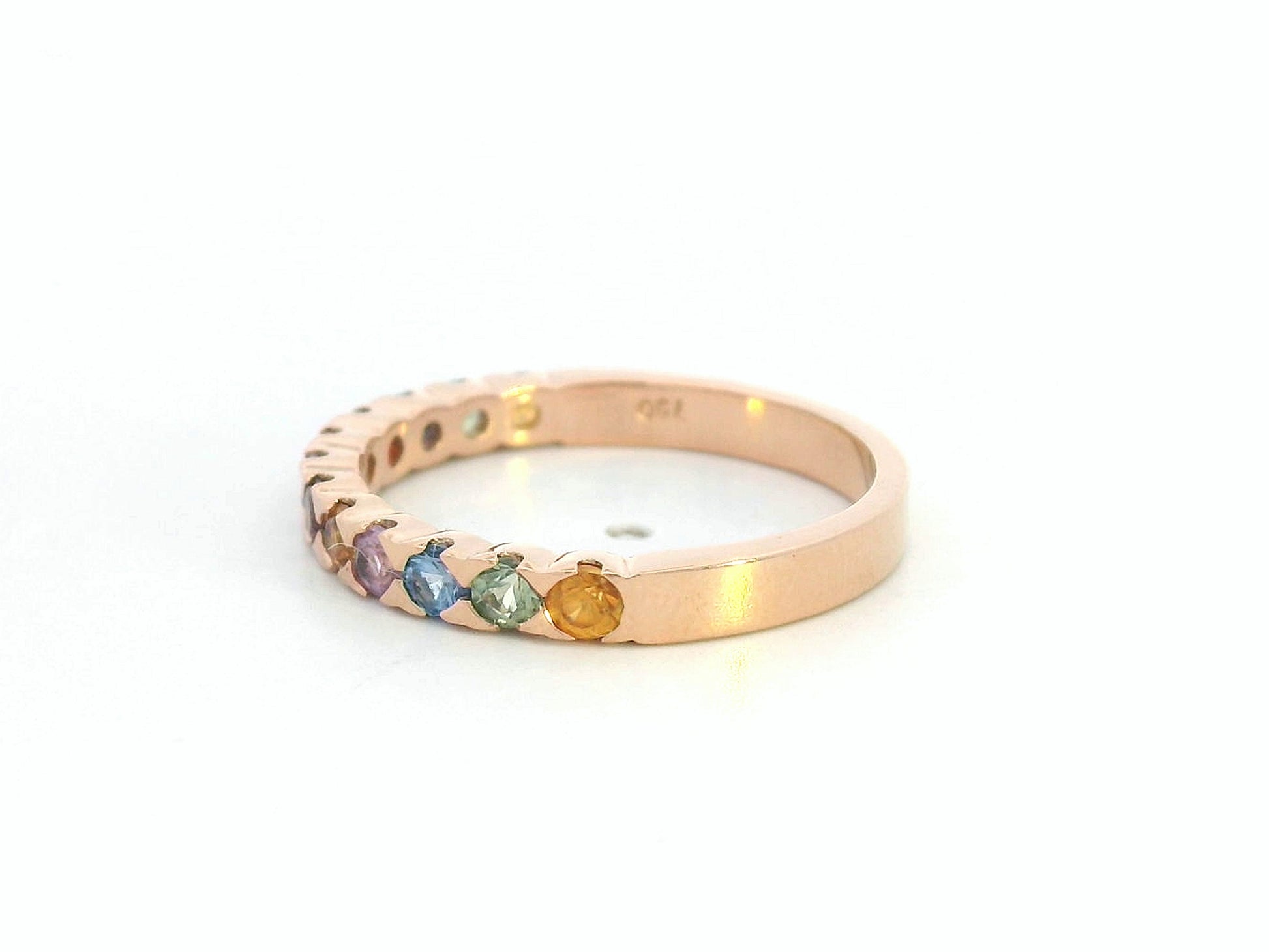 18K rose gold ring set with 0.93 carats of multicolored round sapphires in a half band design