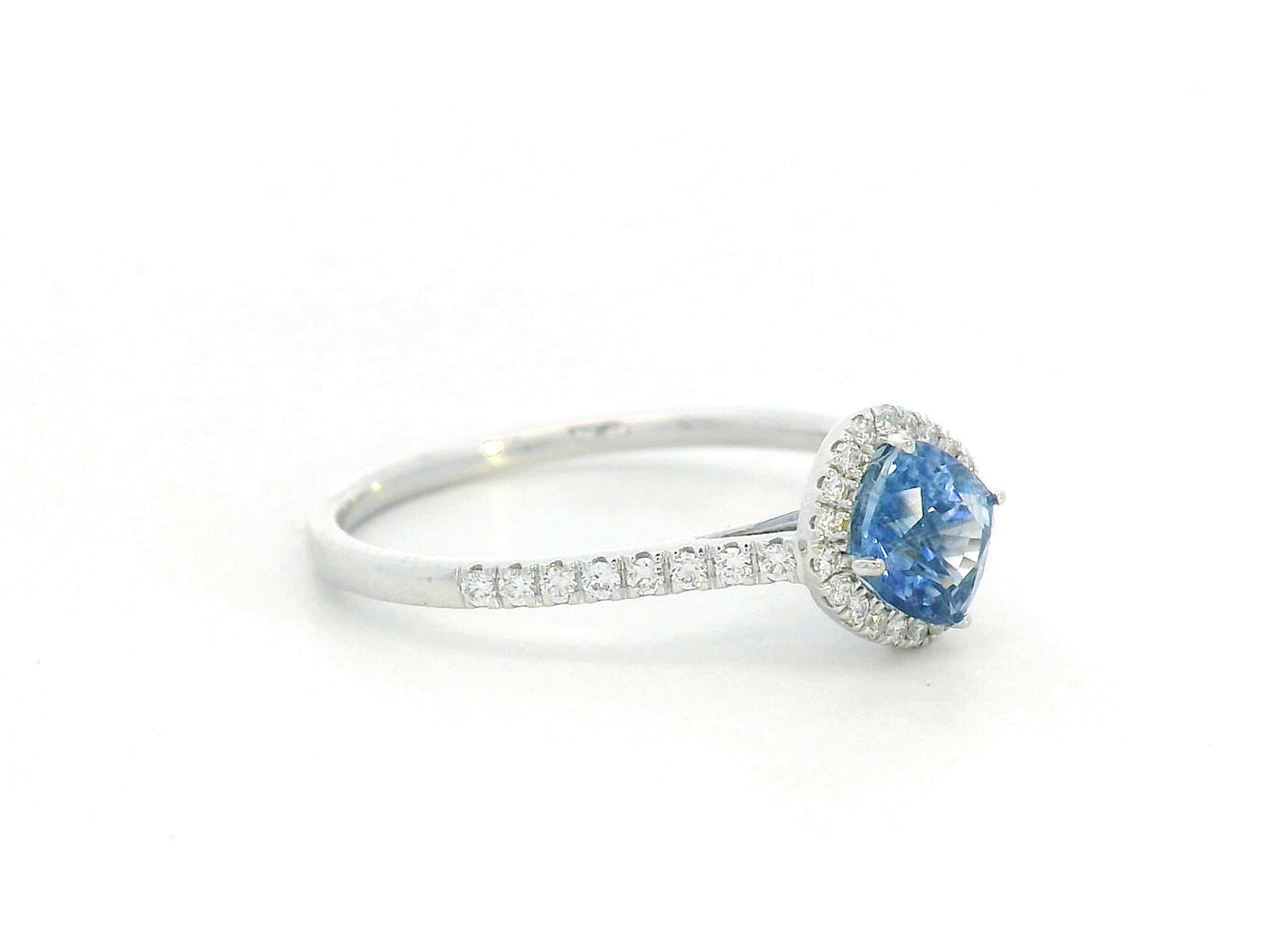 Silver ring with a blue gemstone on a white background