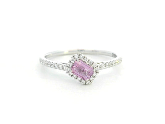 Ring with a pink gemstone and diamond accents on a white background