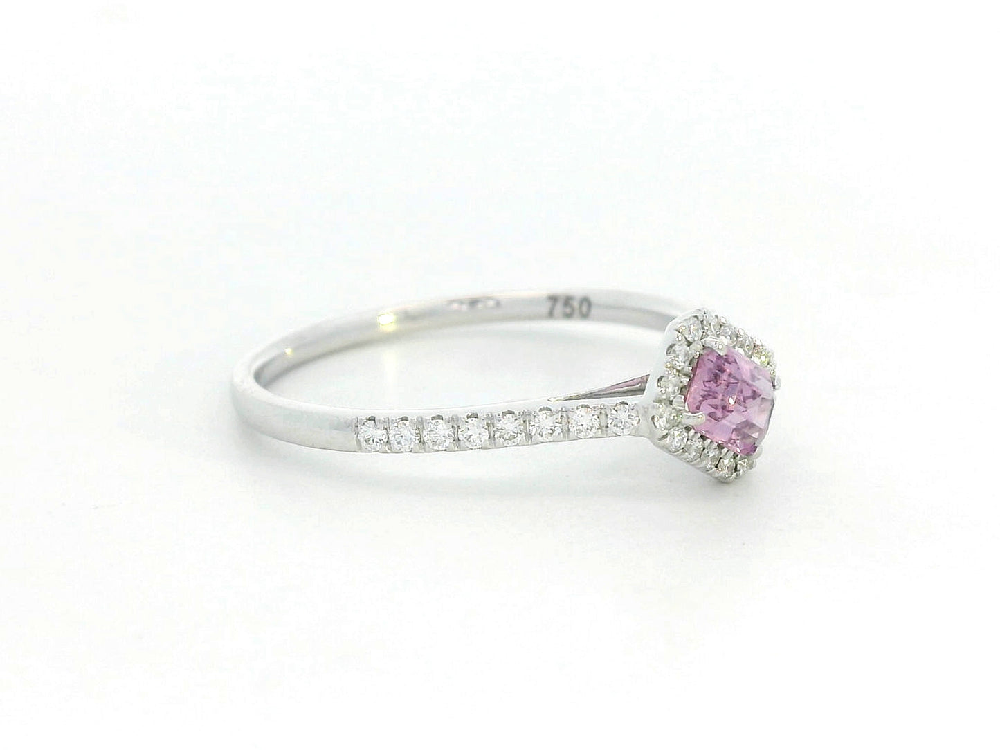 Ring with a pink gemstone and diamond accents on a white background