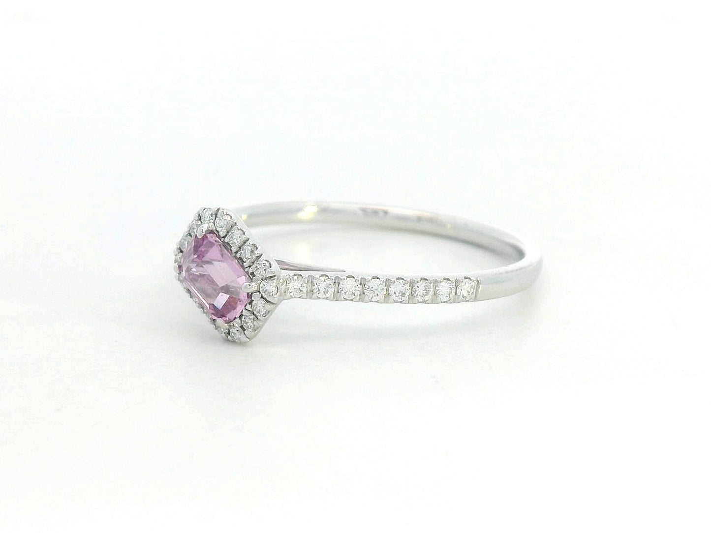 Silver ring with a pink gemstone on a white background