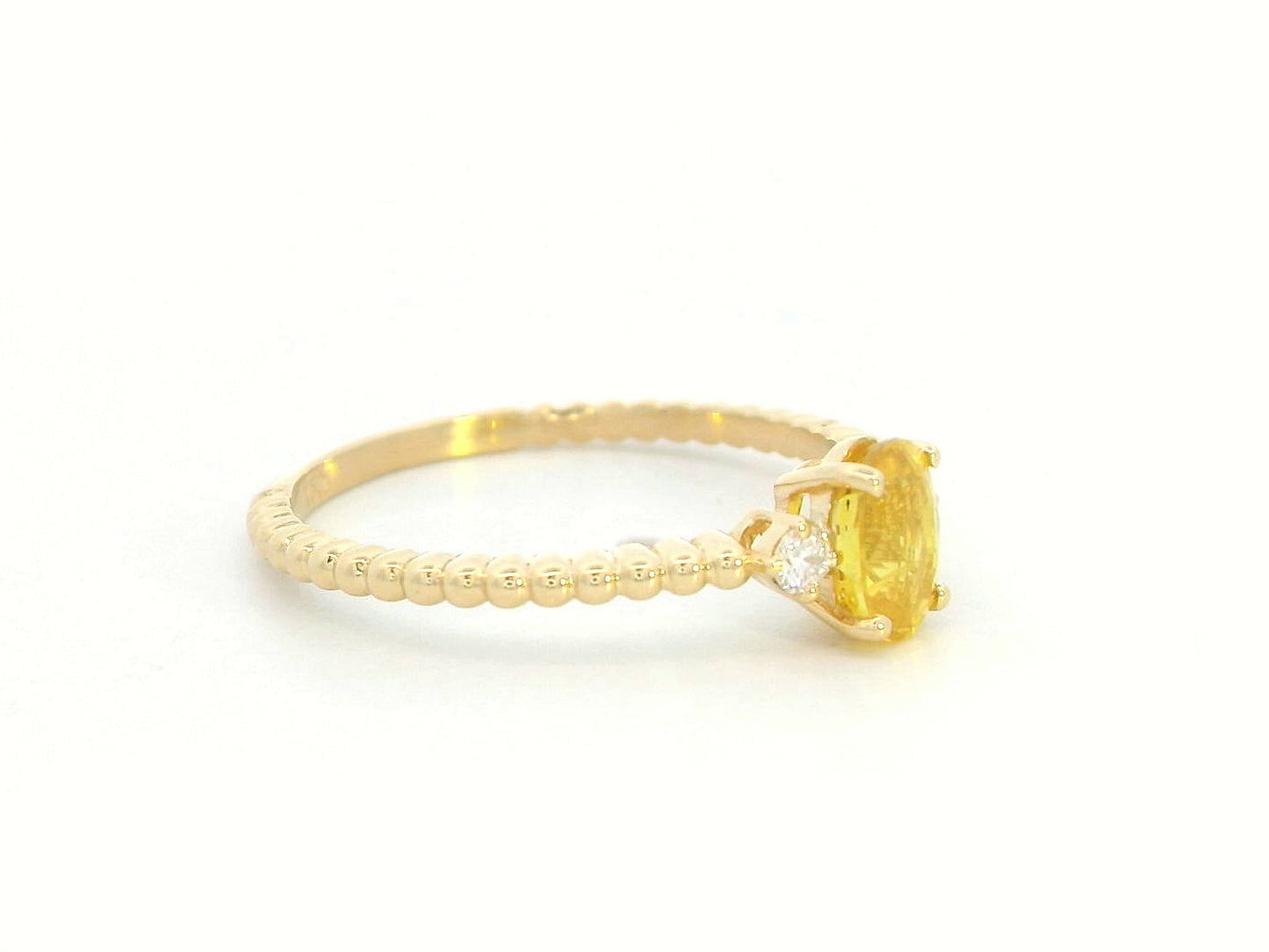 18K gold ring with oval yellow sapphire, side diamonds, and textured beaded band