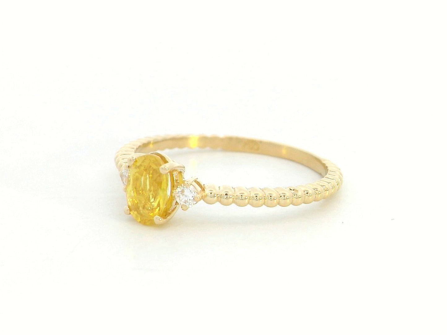 18K gold ring with oval yellow sapphire, side diamonds, and textured beaded band