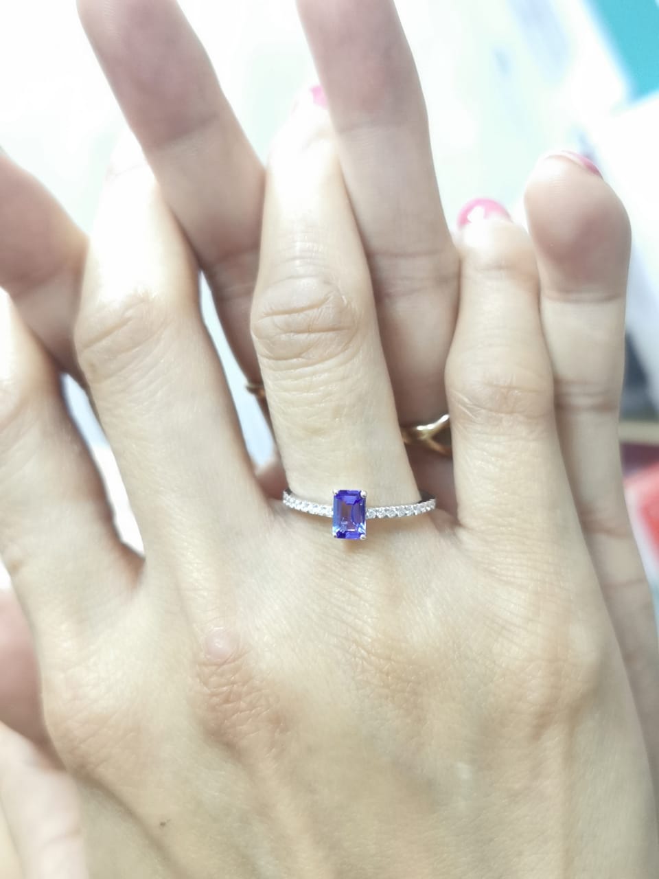 Emerald-cut Tanzanite ring in 18K white gold with diamond-accented band – 0.56ct center stone