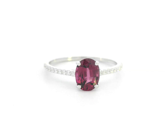 18K white gold ring featuring oval Rhodolite center and diamond-accented band