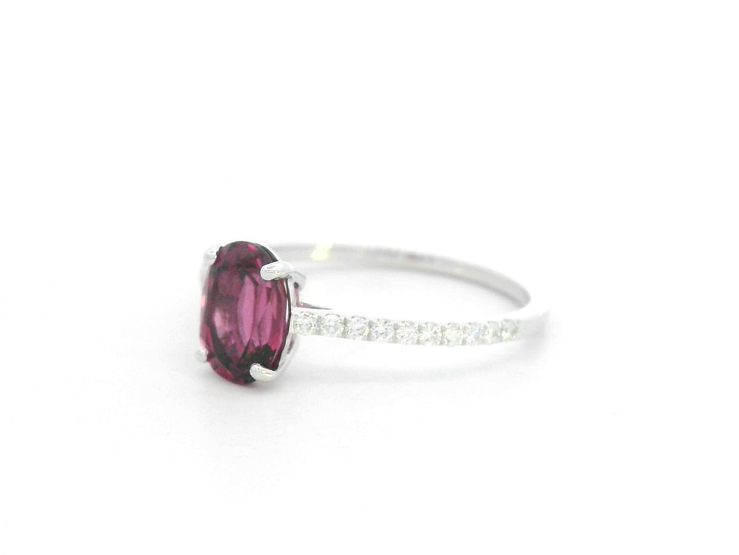 18K white gold ring featuring oval Rhodolite center and diamond-accented band