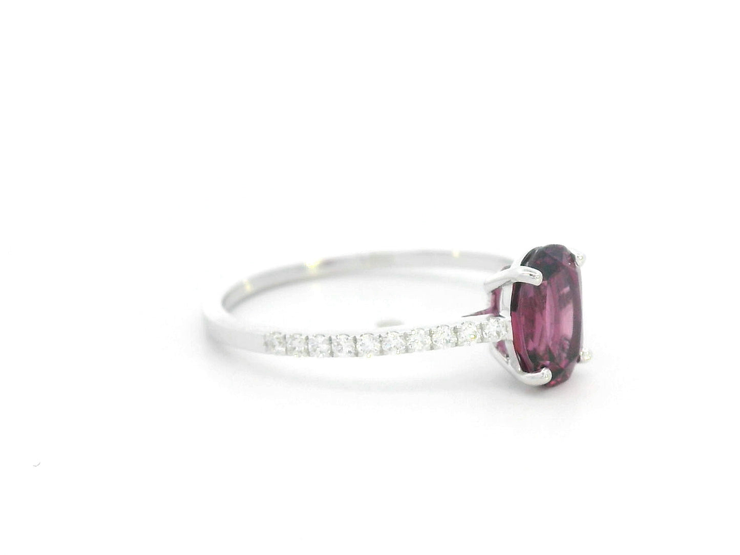18K white gold ring featuring oval Rhodolite center and diamond-accented band