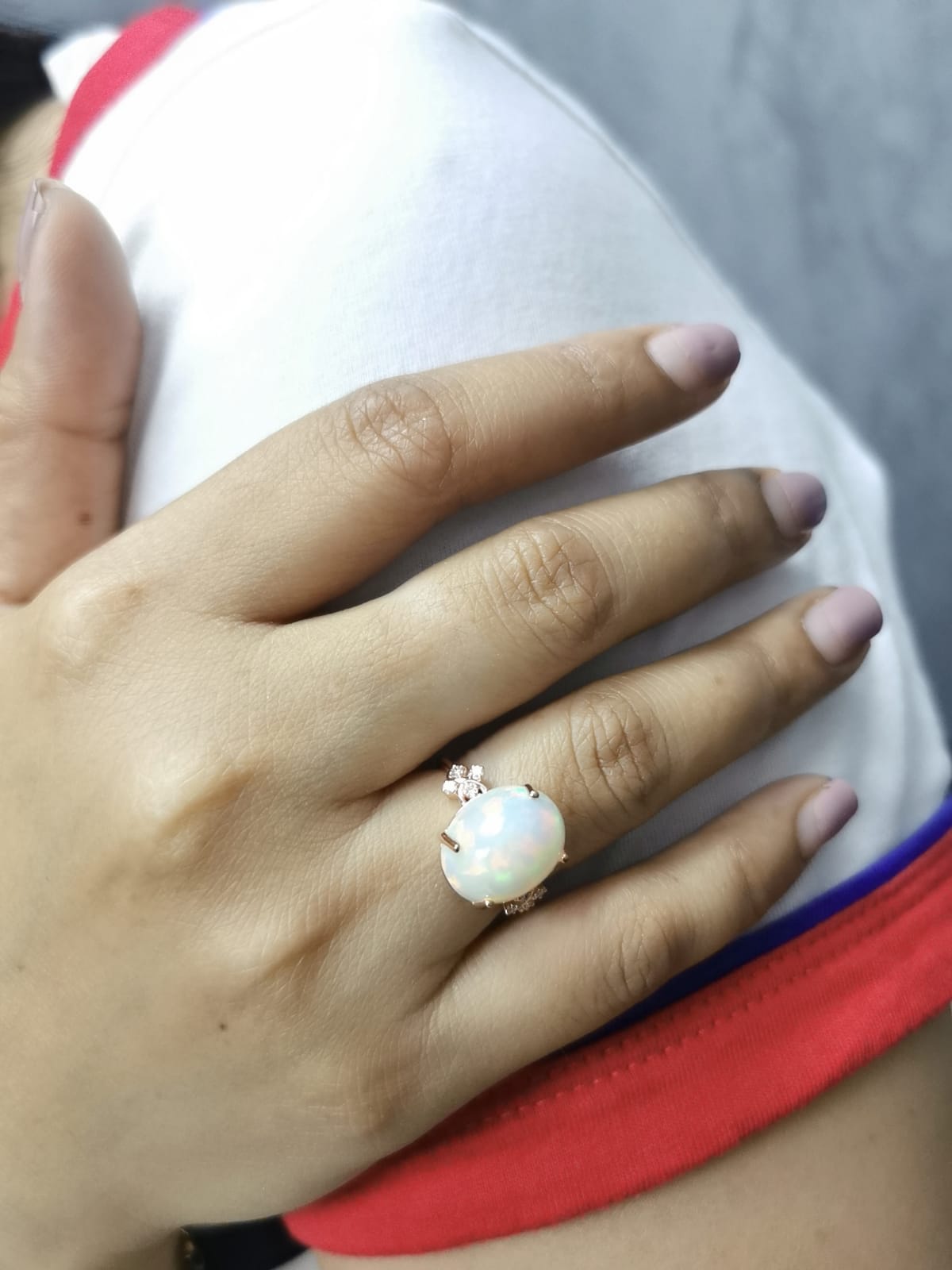 18K rose gold ring with 5.44ct oval opal cabochon and artistic diamond-accented side design