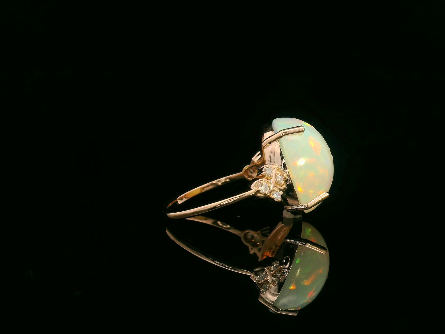 18K rose gold ring with 5.44ct oval opal cabochon and artistic diamond-accented side design