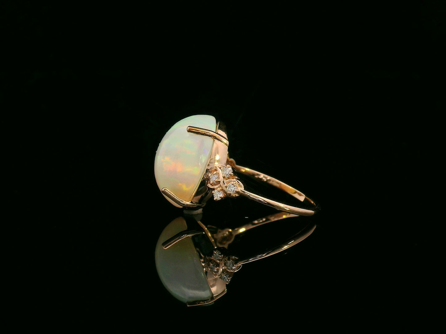 18K rose gold ring with 5.44ct oval opal cabochon and artistic diamond-accented side design