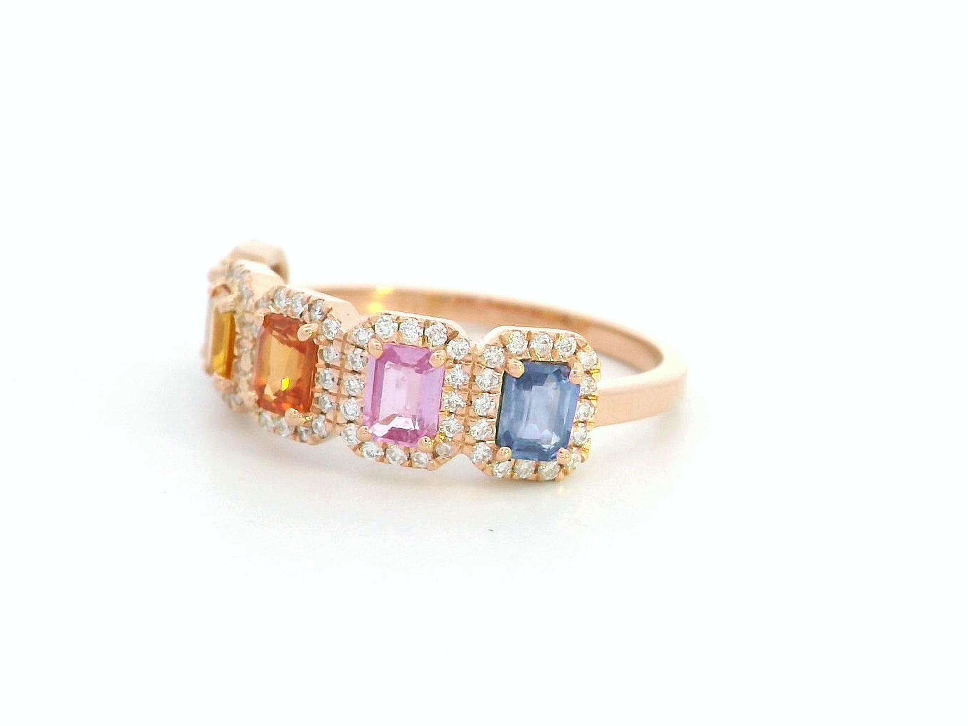 18K rose gold ring with emerald-cut multi-color sapphires and diamond halos