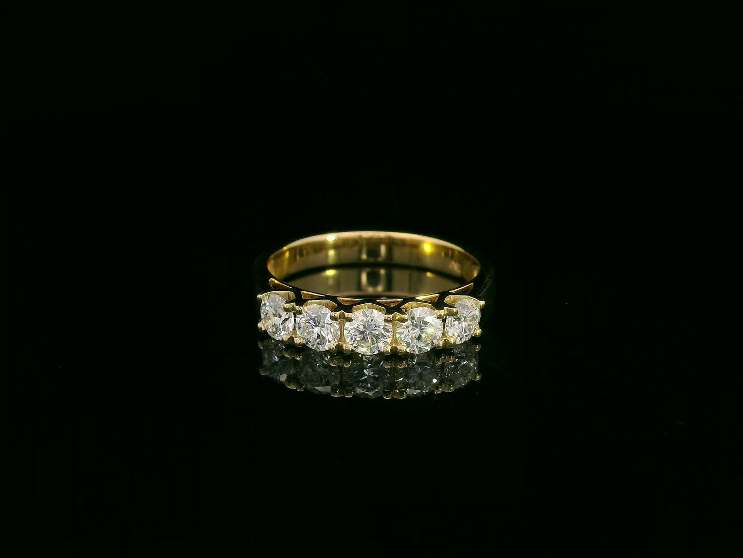 Gold ring with diamonds on a black background