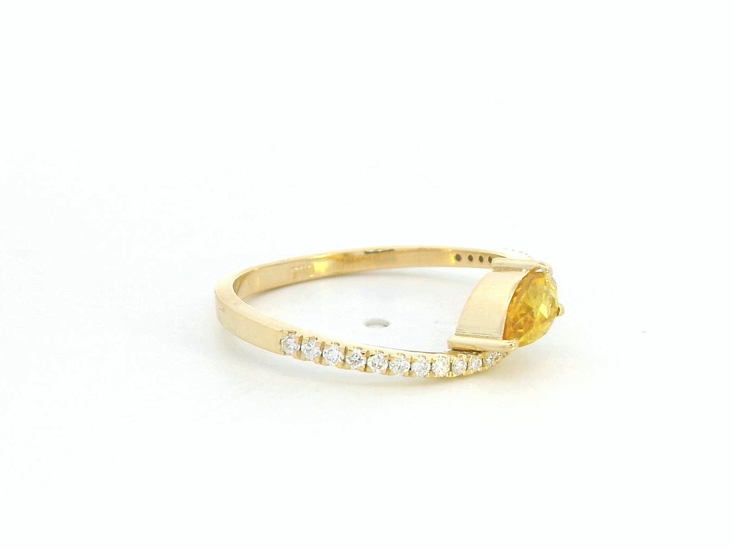 Gold ring with a large gemstone and smaller stones on a white background