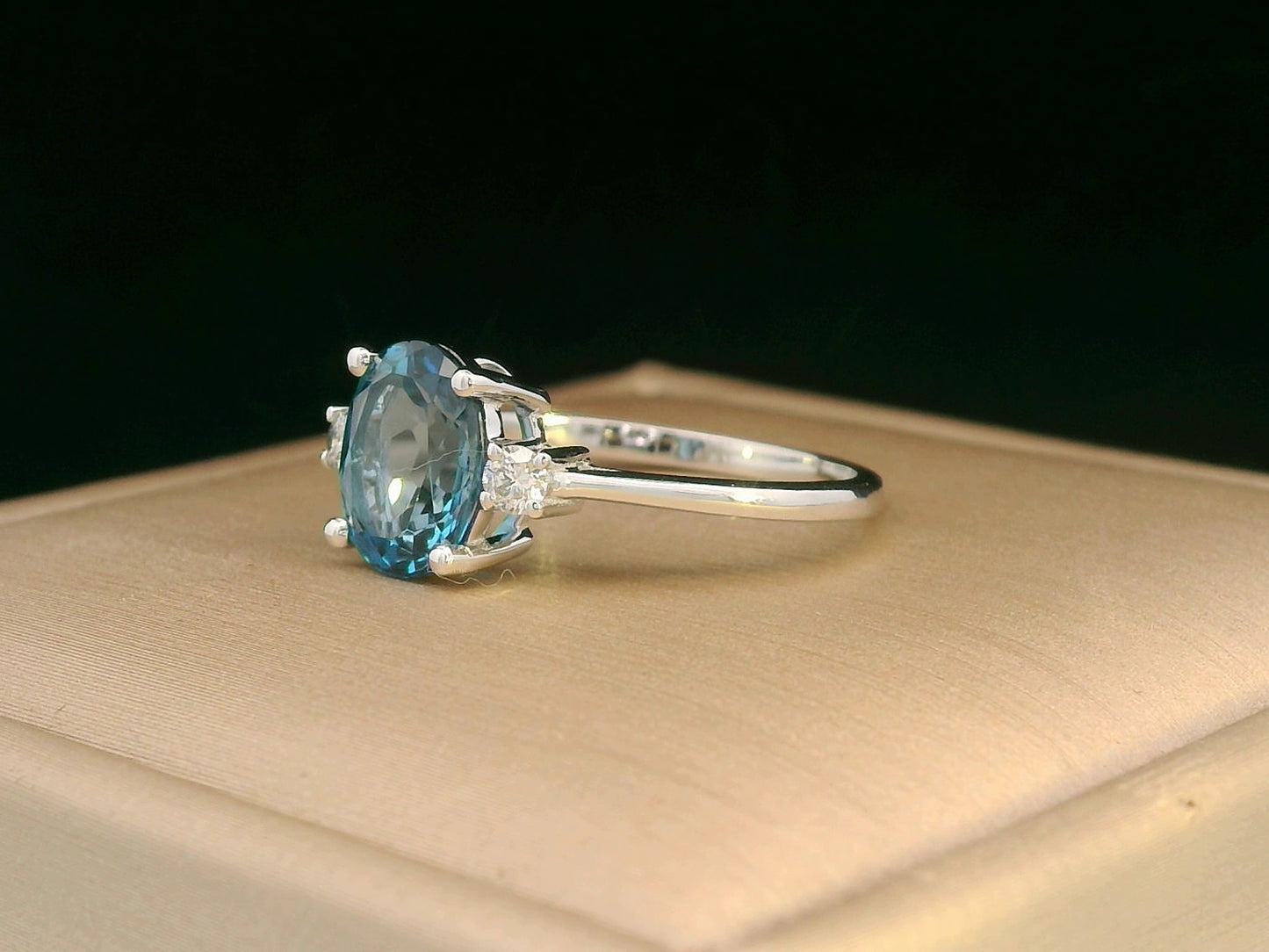 White gold London Blue Topaz ring with round diamond sides