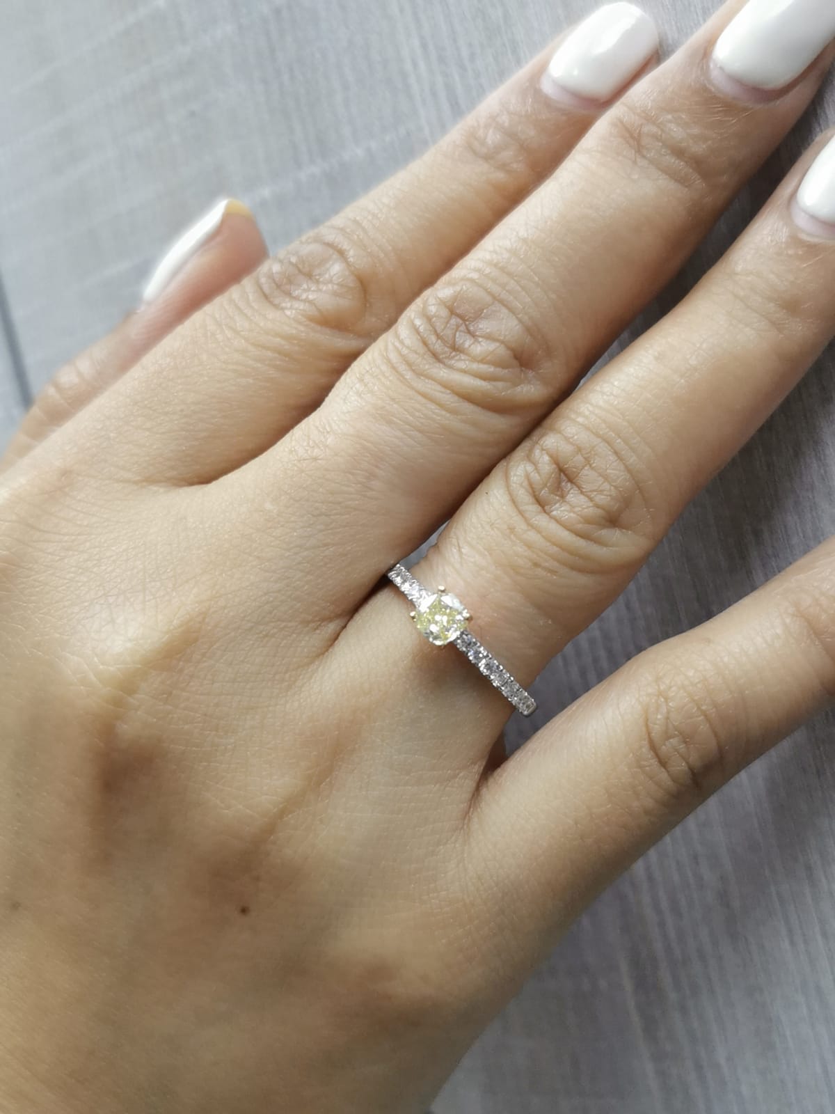 White gold ring with cushion yellow diamond and side diamonds