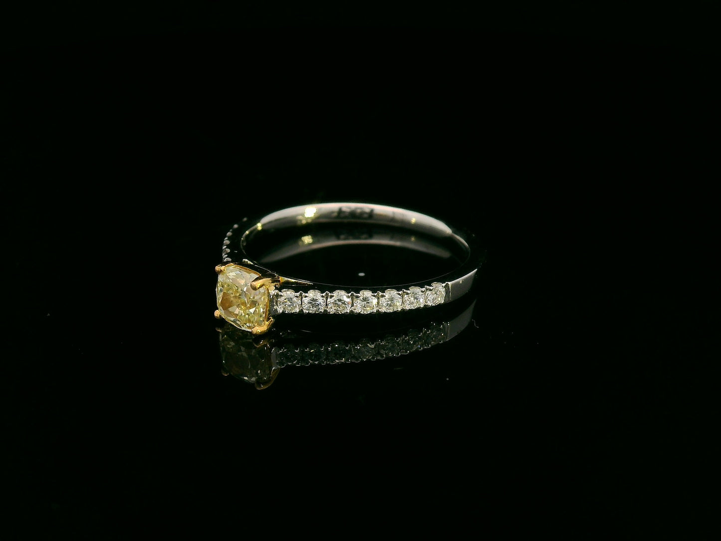 0.57 carat yellow diamond engagement ring with pave diamond band