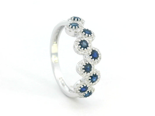 18K white gold ring with blue sapphires and diamond halo