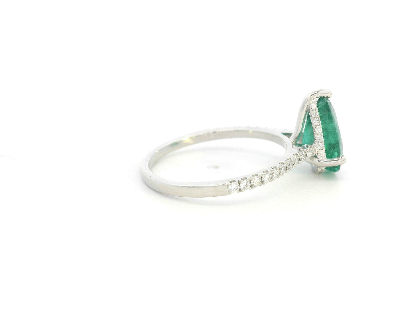 Emerald center ring with pavé-set diamonds in white gold