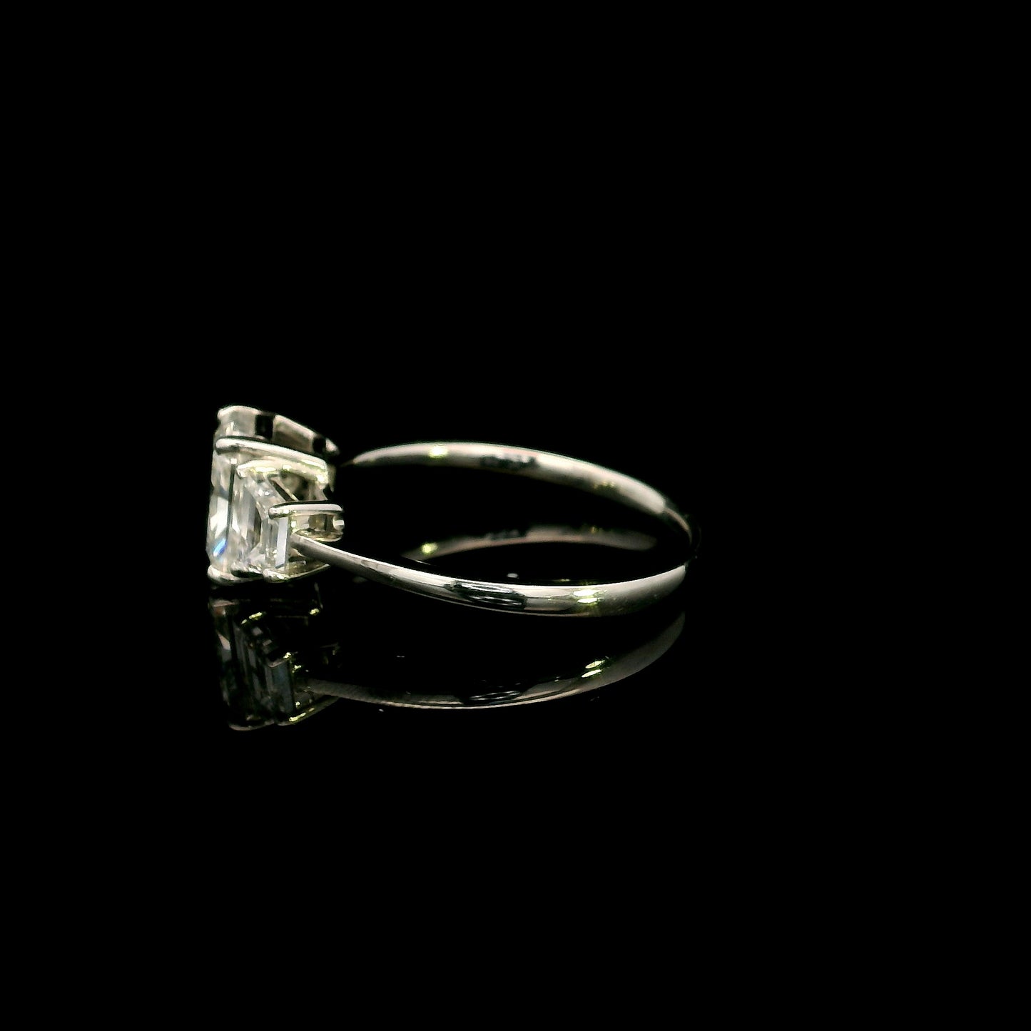 18K white gold radiant cut diamond engagement ring with a 1.51 carat HRD certified centre diamond and trapezoid side diamonds.