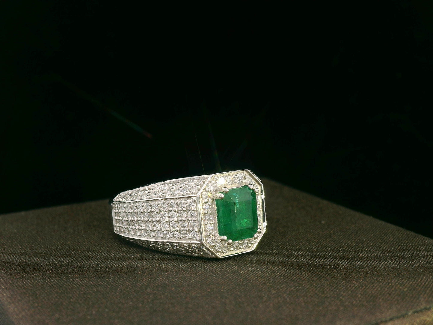 18K white gold men’s ring with emerald-cut emerald and diamond halo.