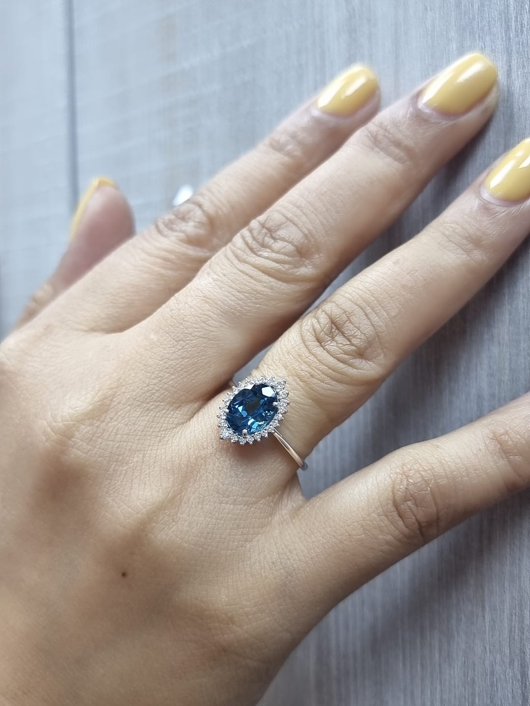 18k white gold London Blue Topaz and diamond halo ring