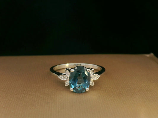 18k white gold ring with 2.35ct oval London Blue Topaz and 0.04ct diamond floral accents – certificate included