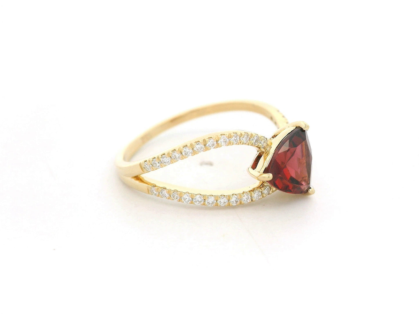18k yellow gold ring with trillion-cut garnet and diamond crossover band. Comes with a certificate of authenticity