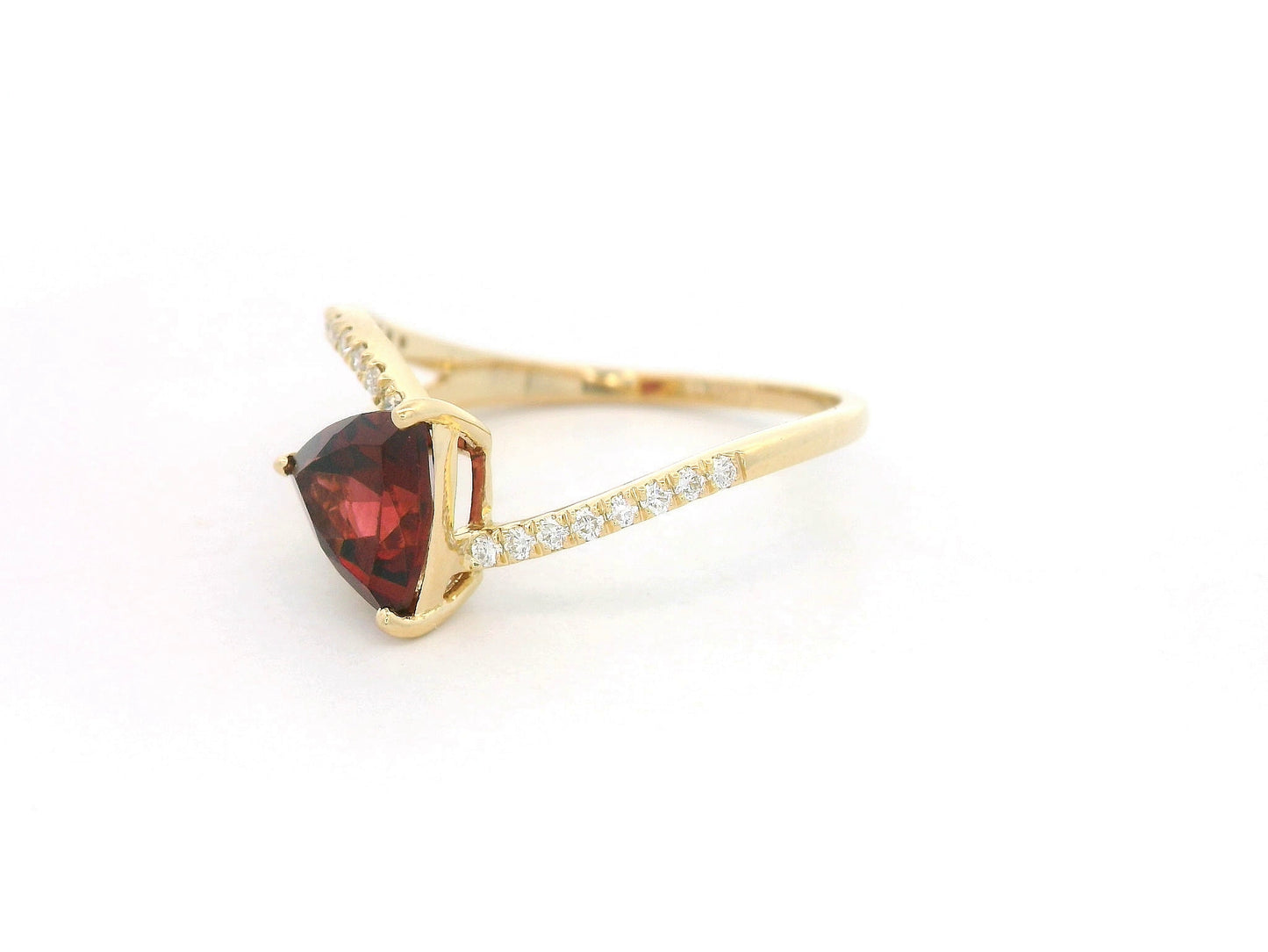 18k yellow gold ring with trillion-cut garnet and diamond crossover band. Comes with a certificate of authenticity